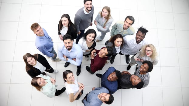 multicultural successful business group looking up in office corridor