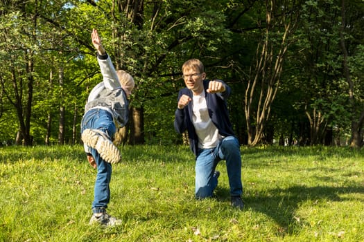 Cute Caucasian 7 Yo Boy Puts, Inserts Flower In Mother's Hair In Park. Mom And Dad Lying On Grass. Summer Time. Parenthood, Family Leisure Time. Love And Care. Horizontal Plane. High quality photo