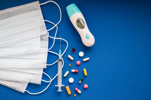 medicine next to a syringe. Medicines for the virus and flu. Medical pills and antibiotics. Coronavirus.