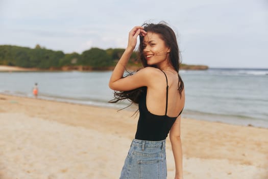 beach woman outdoor coast lifestyle sea enjoyment sand happy ocean peaceful copy-space sunset vacation girl dress smile summer smiling running relax