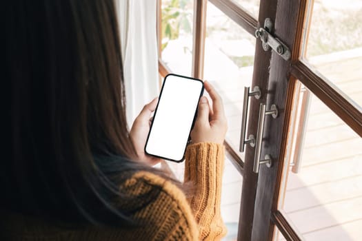 mock up phone in woman hand showing white screen. mock up phone in woman hand showing white screen.