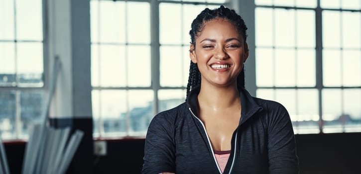 Happy when her workout is complete. Portrait of a young woman in a gym