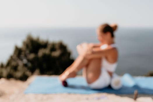 Fitness woman sea. Outdoor workout on yoga mat in park near to ocean beach. Female fitness pilates yoga routine concept. Healthy lifestyle. Happy fit woman exercising with rubber band in park.