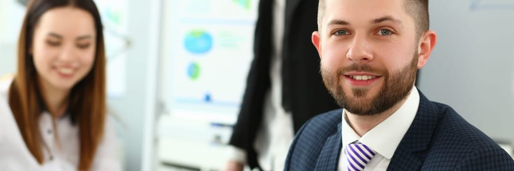 Portrait of handsome young man at business meeting. Joint successful teamwork concept