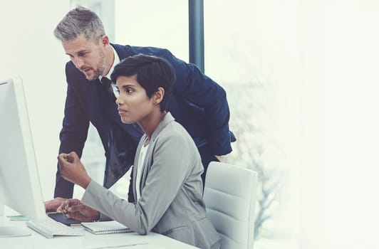 Double the productivity with technology and teamwork. a businesswoman and businessman using a computer together at work