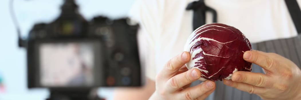 cook blogger holds cabbage and makes video about proper nutrition. Dietetics course concept