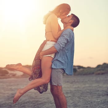 One awesome kiss deserves another. an affectionate young couple at the beach