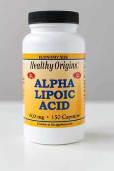 Kyiv, Ukraine - 27 January 2022: Jar with capsules Alpha Lipoic Acid from Healthy Origins. ALA pills is an organosulfur compound is made in animals normally, and is essential for aerobic metabolism