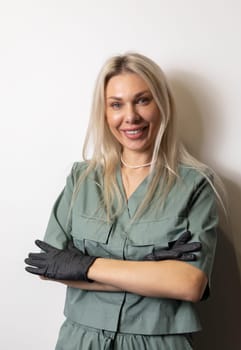 Mockup Female Cosmetic Physician, Beauty Doctor With Venire Teeth Smile Wears Khaki Uniform, Clothes, Black Gloves On White Background. Vertical Plane. High quality photo