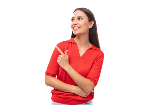 portrait of a cute young european brunette lady in a red t-shirt actively gesturing with her index finger towards the wall.