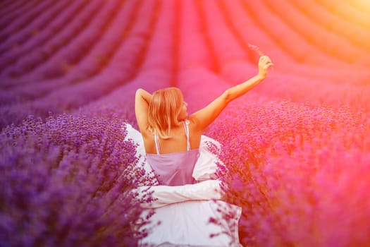 Woman lavender field. A middle-aged woman sits in a lavender field and enjoys aromatherapy. Aromatherapy concept, lavender oil, photo session in lavender.