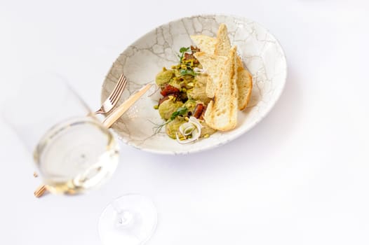 Hummus with pistachios, coconut and croutons with a glass of wine