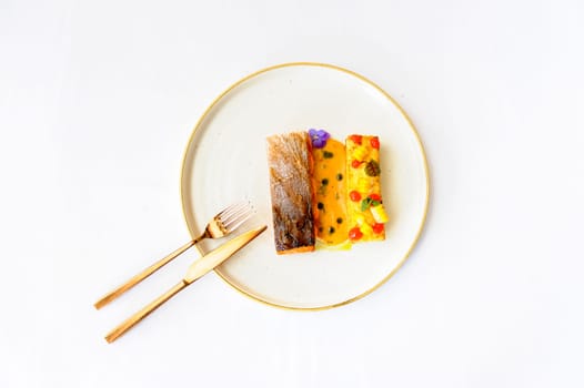 Exquisite serving of salmon steak on a white plate on a white background
