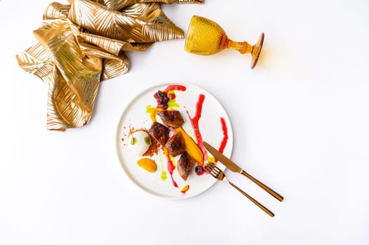 Exquisite serving of duck with cowberry sauce and ice cream isolated