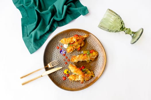 Exquisite serving of shrimps in batter on a brown plate on a white background