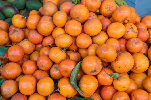 Pile of tangerines for sale at a market