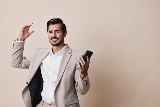 man blogger beard smartphone phone application portrait hold selfies success cyberspace beige confident business male lifestyle call happy suit background smile