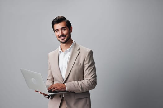 man adult internet office background typing computer job copyspace smiling business beard studio laptop freelancer network using suit smile white beige