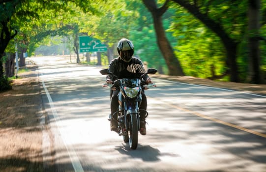 Male motorcyclist driving at high speed on the street. Motorcycle driver at full speed on the highway.