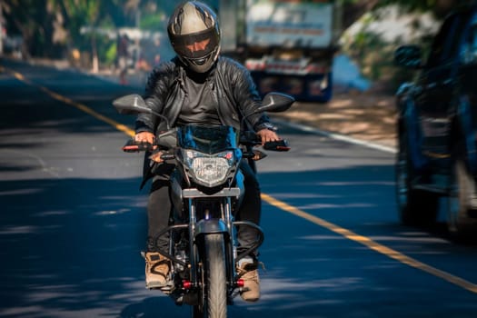 Male biker driving at high speed on the street. Motorcycle driver at full speed on the highway.