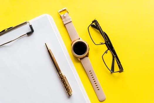 Home office workspace mockup with clipboard, glasses and accessories. Flat lay, top view.