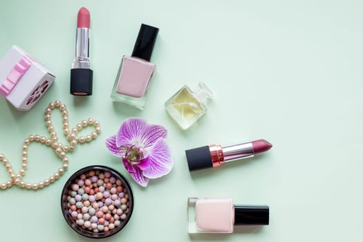 Colorful make up products with golden pursue close up pop art flat lay scene