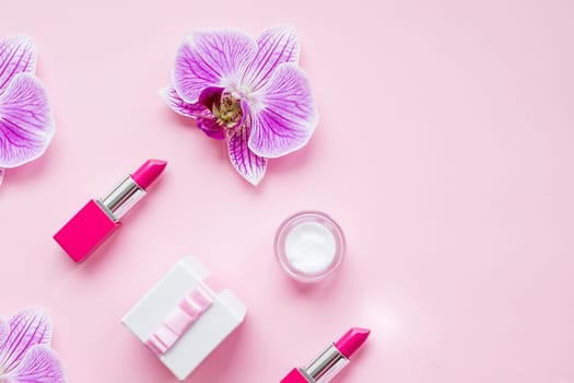 Makeup natural cosmetic products against green color background. Make up female accessories