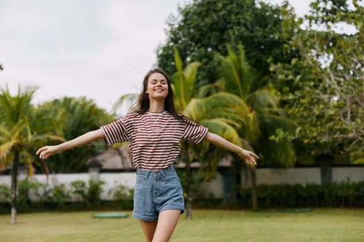 woman nature active outdoor summer lifestyle portrait exercise carefree happy beautiful walk quiet happiness t-shirt hat freedom smiling park hipster meadow