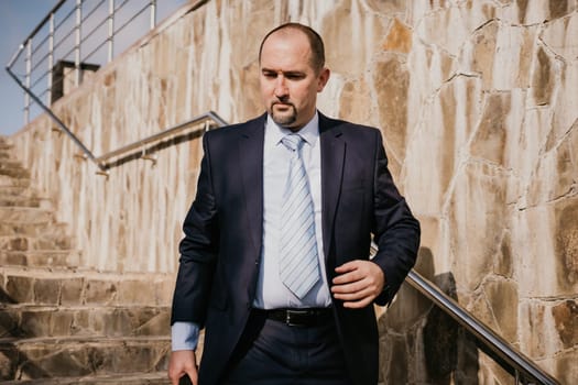 Business executive with briefcase going down the stairs.