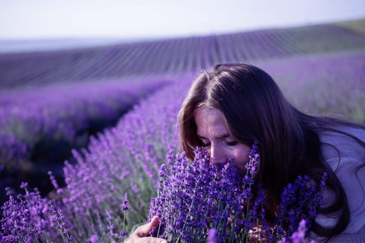 Lavender flower blooming scented fields in endless rows. Selective focus on Bushes of lavender purple aromatic flowers at lavender field. Abstract blur for background.