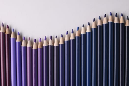 Set of blue colored pencils in row. Different blue shades in colored pencils concept