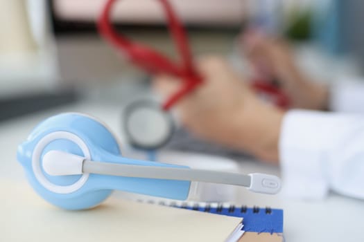 Doctor holds a stethoscope and provides medical care remotely. Telemedicine services concept