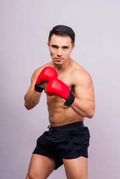 Professional athlete boxer in red gloves isolated on studio. Sport, competition concept.
