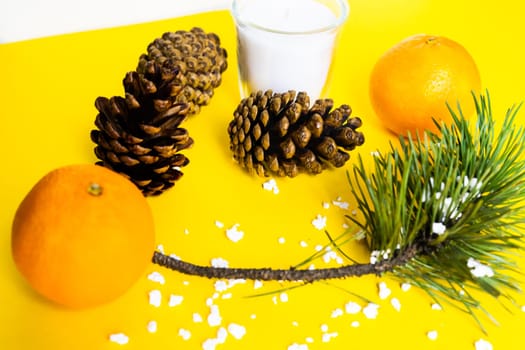 Christmas background with a fir tree branches and tangerines. Merry Christmas and Happy New Year