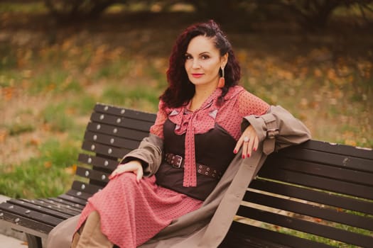 A woman walks outdoors in autumn, enjoys the autumn weather