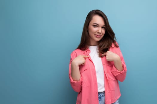 pretty cute european woman in pink shirt isolated studio background.