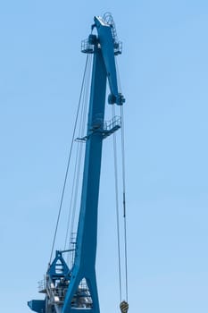 Port crane on a blue sky background. photo