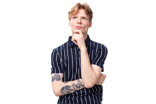 handsome pensive young blond man on white background.