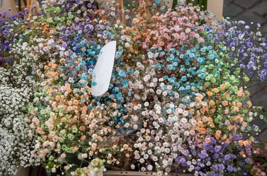 bouquet of bright different colors blooming gypsophila in the street market, background from small flowers, High quality photo