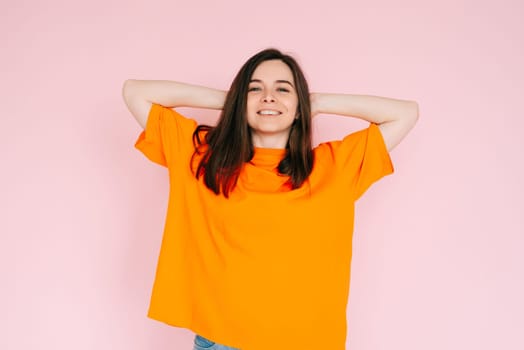 Summer Daydreams: Cheerful Woman in Comfortable Attire, Hands Behind Head, Imagining the Bliss of Summer - Optimism and Anticipation Concept, Isolated on Pink Background