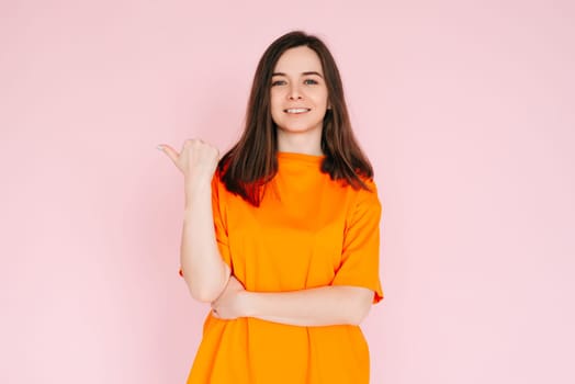 Positive Affirmation: Lovely Woman Pointing Thumb at Empty Space - Encouraging Positivity and Possibilities, Isolated on Pink Background