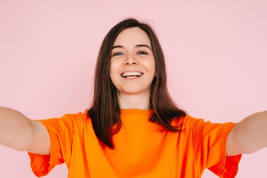 Vibrant Social Media Storytelling: Beautiful and Joyful Woman in Colorful Attire, Recording Instagram Twitter Post - Influencer and Informant Concept, Isolated on Pink Background
