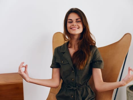 Woman model sits on a chair at home smile, fun and relaxation, modern stylish interior scandia lifestyle, copy space. High quality photo