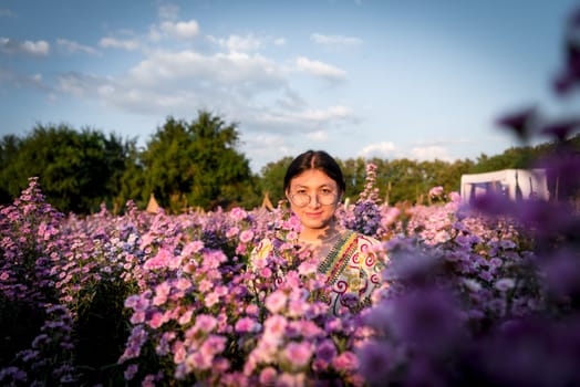 Beautiful asian woman (LGBTQ) natural makeup wear fashion relax clothes posing at nature of flower park or flower garden field lush growing for travel popular landmark in asia outdoor fashion style