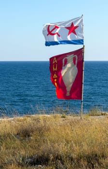 UKRAINE, CRIMEA - AUGUST 05, 2011: flag with an amphora and a naval ensign against the backdrop of the Black Sea