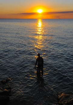Human silhouette against the background of the sunrise over the Black Sea in the Eastern Crimea