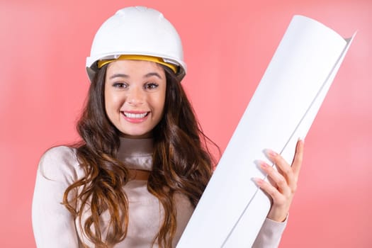 Wearing a white hardhat, a smiling woman architect embraces her job with a delighted expression, finding joy in her work.
