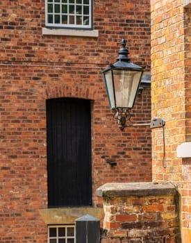 Exterior of restored cotton spinning and weaving mill in north of England with focus gas light