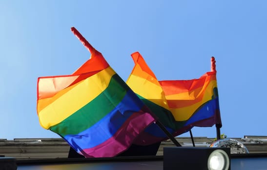 Pride rainbow lgbt gay flag being waved on sky bg