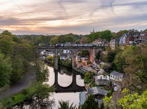 Stone viaduct over River Nidd at Knaresborough with train carriages on bridge